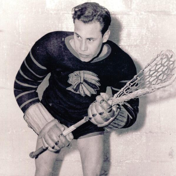 Bill Isaccs poses with his lacrosse gear, black and white