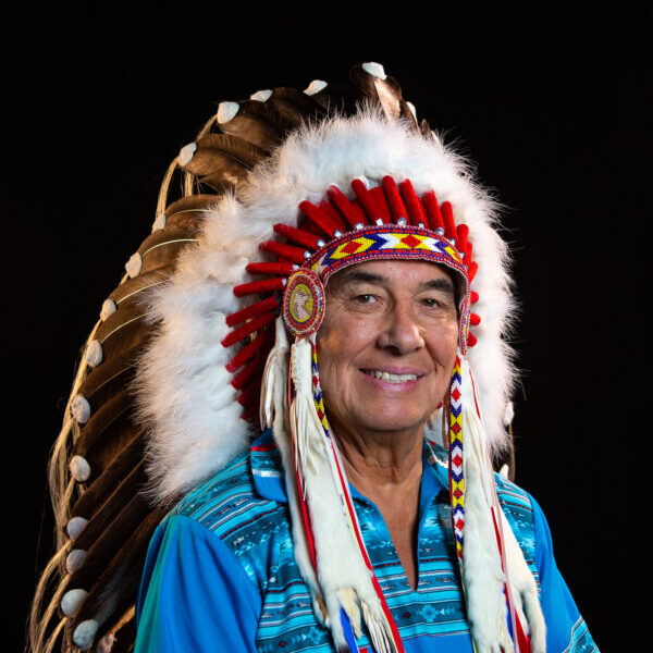 Chief Wilton Littlechild poses for a portrait in his traditional First Nations head dress